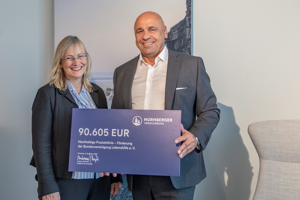 Jeanne Nicklas-Faust, Bundesgeschäftsführerin der Bundesvereinigung Lebenshilfe e. V. und Andreas Politycki, Vorstand Vertrieb und Marketing der Nürnberger Versicherung, bei der symbolischen Scheckübergabe. Foto: Chr. Kähl/Nürnberger Versicherung 