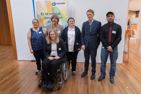 Selbstvertreterin Claudia Franke (vorne im Rollstuhl sitzend) beim Parlamentarischen Abend 2022 der Bundesvereinigung Lebenshilfe zusammen mit, von links: Selbstvertreterin Ramona Günther, Lebenshilfe-Bundesvorsitzende Ulla Schmidt, Selbstvertreterin Manuela Stock, Bundesgesundheitsminister Karl Lauterbach und Selbstvertreter Sascha Ubrig.