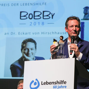 Dr. Eckart von Hirschhausen am Rednerpult in der Marburger Stadthalle.